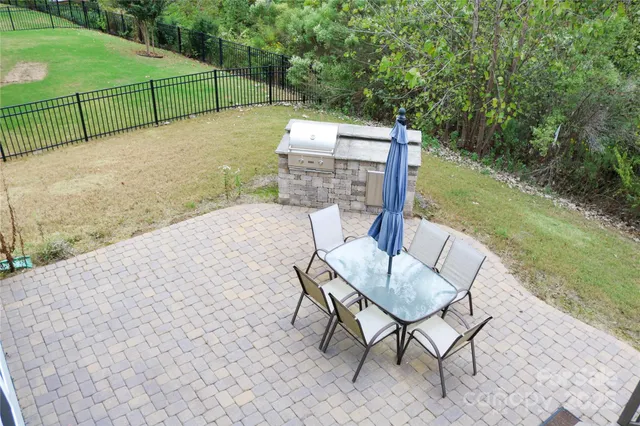 a view of a chairs and table in backyard