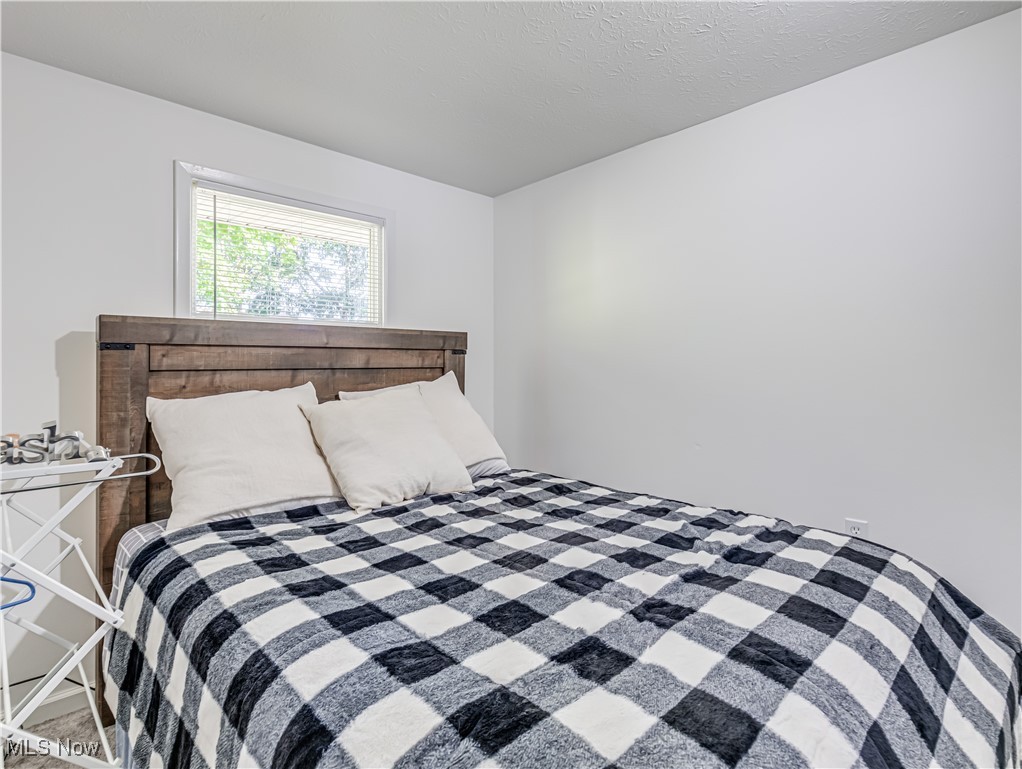 1119 Chaparrel Road Southwest Hartville, OH 44632 - Photo 6 of 23 Bedroom featuring a textured ceiling