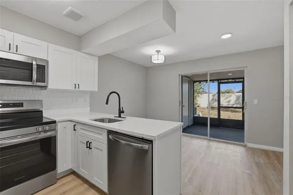 a kitchen with a sink and a stove top oven