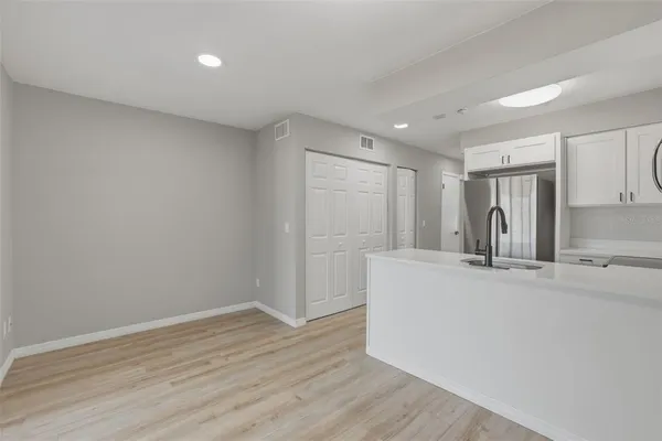a view of kitchen with wooden floor and refrigerator
