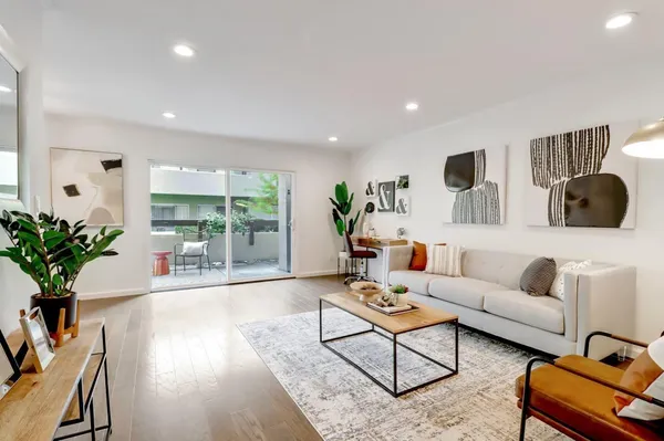 a living room with furniture and a floor to ceiling window