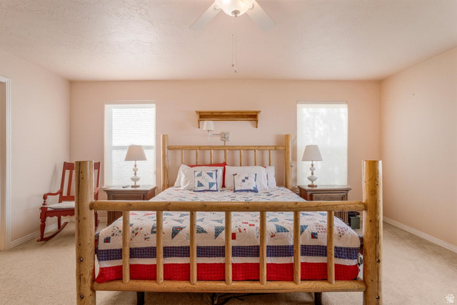 48 South Sage Road Pine Valley, UT 84781 - Photo 23 of 61 Comfortable interior space featuring two windows with blinds, a ceiling fan, and carpeted flooring