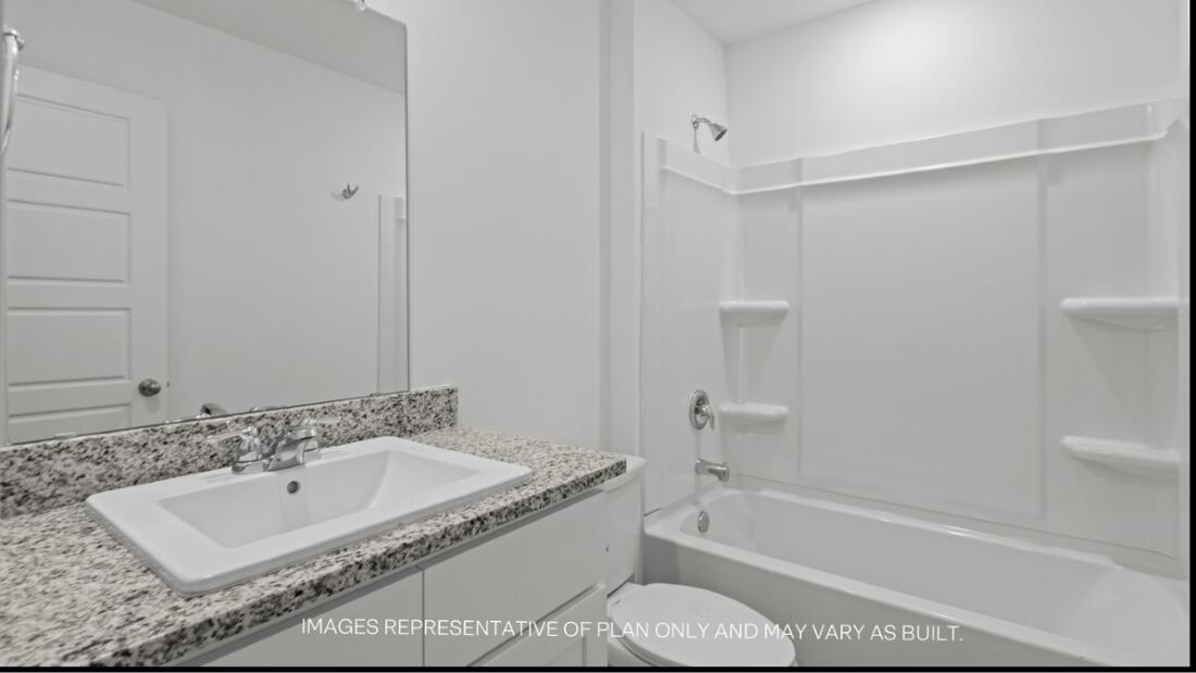 2303 150th Place Lubbock, TX 79423 - Photo 16 of 19 a bathroom with a granite countertop tub sink and mirror