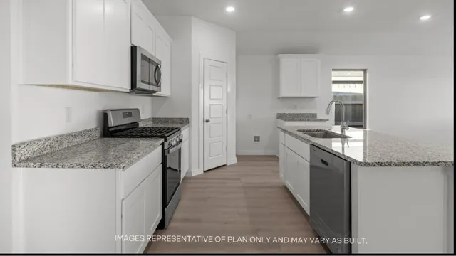 a kitchen with stainless steel appliances granite countertop a stove a sink and a microwave