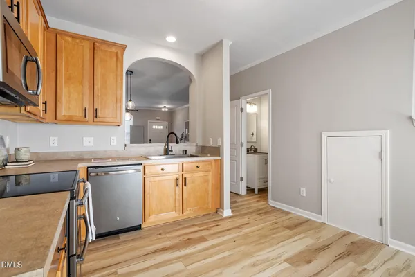a kitchen with a sink cabinets and wooden floor