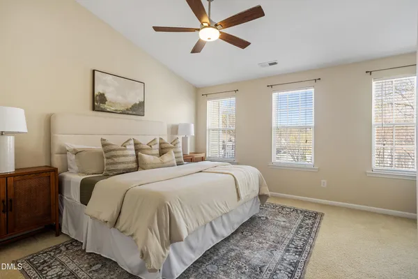 a bedroom with a bed and a painting on the wall