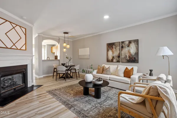 a living room with furniture a fireplace and a table
