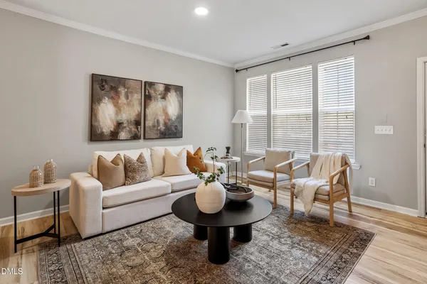 a living room with furniture and wooden floor