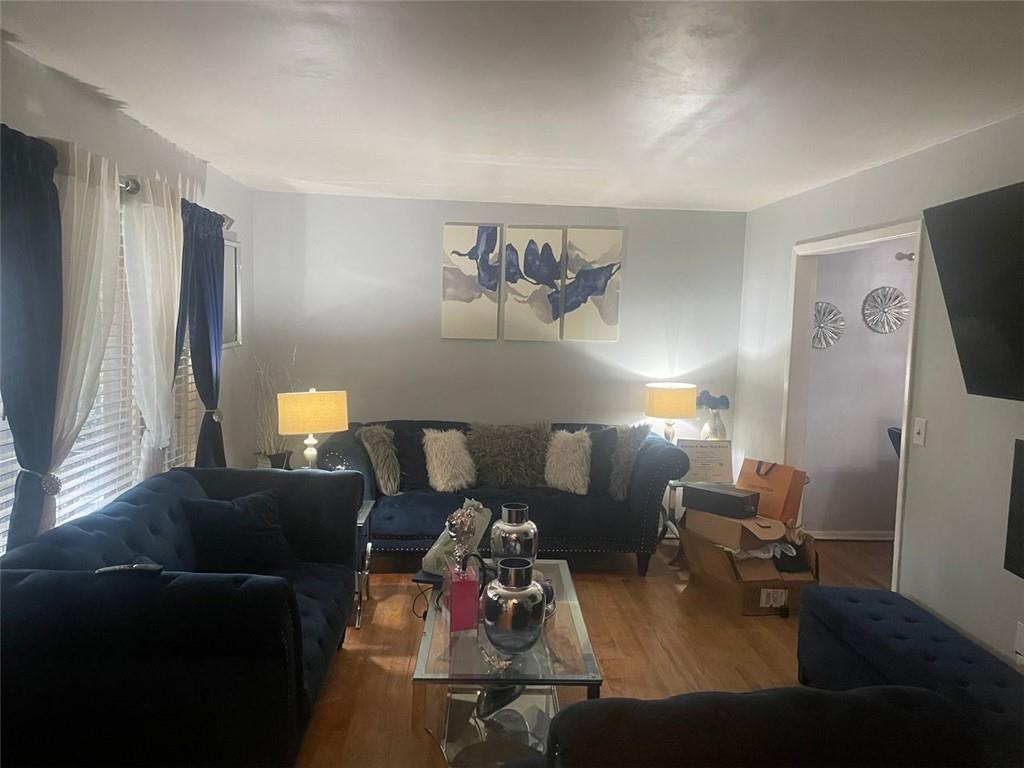 4015 Bakers Ferry Road Southwest Atlanta, GA 30331 - Photo 2 of 7 a living room with furniture and a flat screen tv