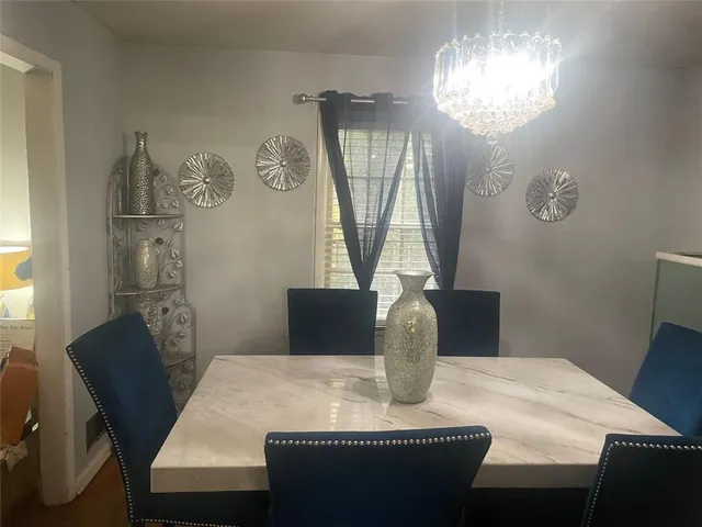 a view of a dining room with furniture and chandelier