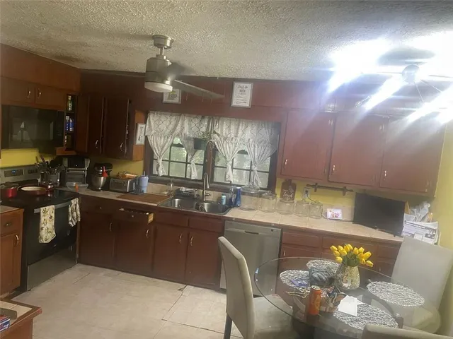 a kitchen with counter top space cabinets and appliances