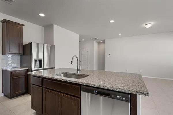 a kitchen with stainless steel appliances granite countertop a sink stove and cabinets