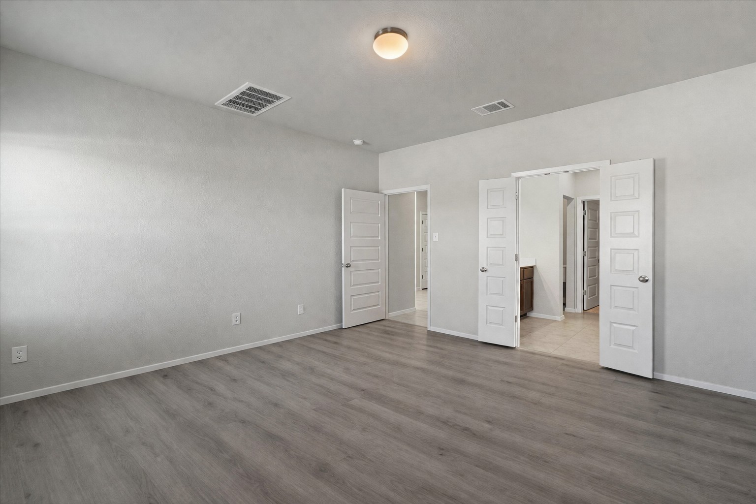 2711 Winding Creek Road Kyle, TX 78640 - Photo 15 of 33 a view of an empty room with wooden floor and closet