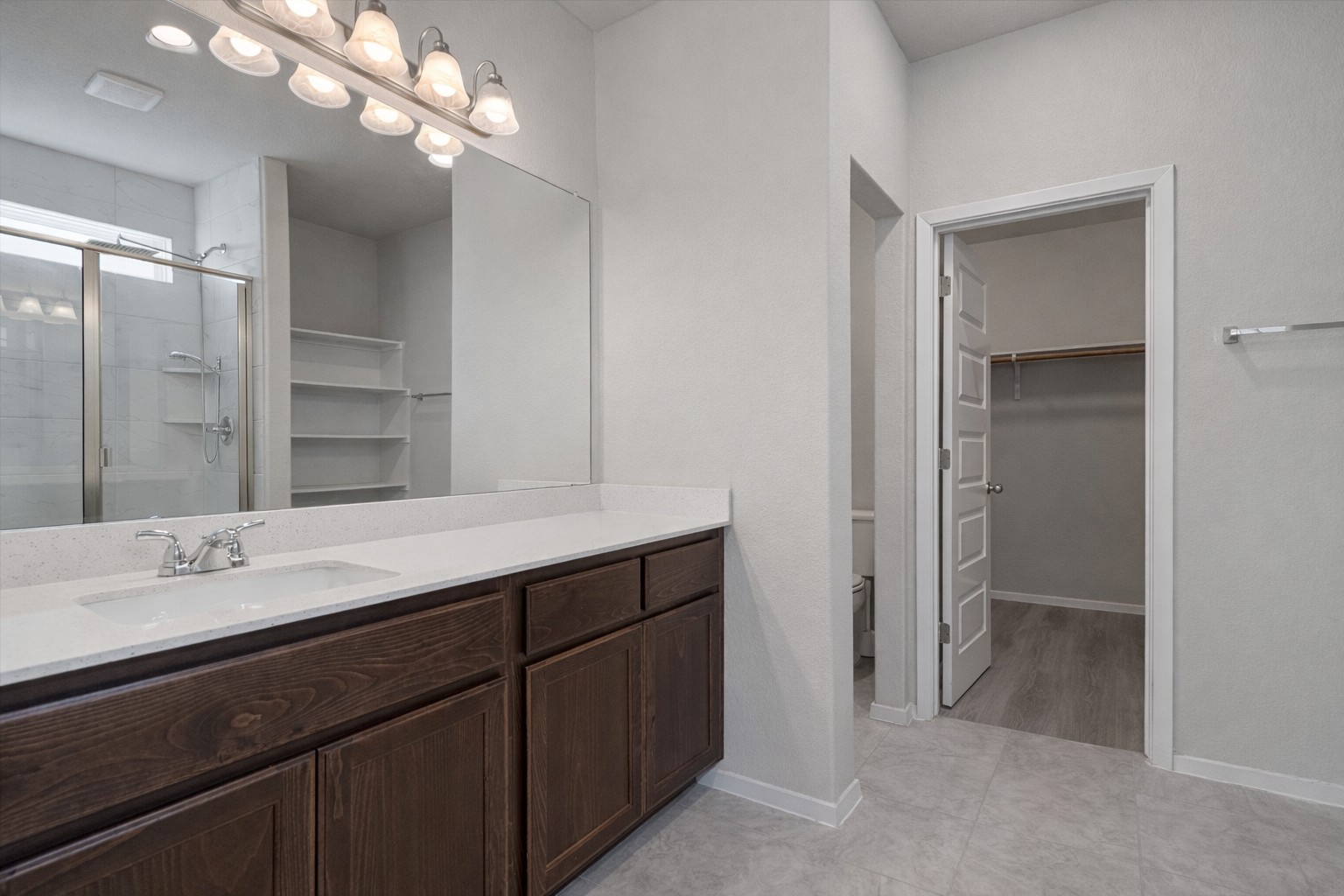 2711 Winding Creek Road Kyle, TX 78640 - Photo 17 of 33 a bathroom with a sink double vanity and a mirror