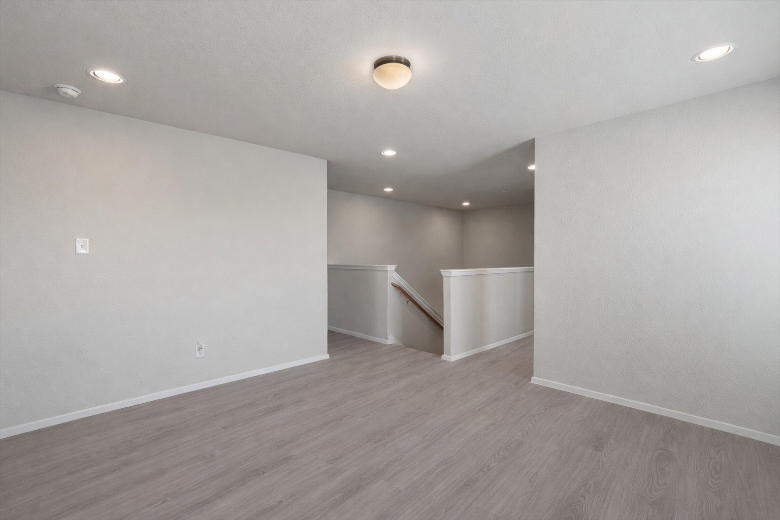 2711 Winding Creek Road Kyle, TX 78640 - Photo 22 of 33 an empty room with wooden floor and windows