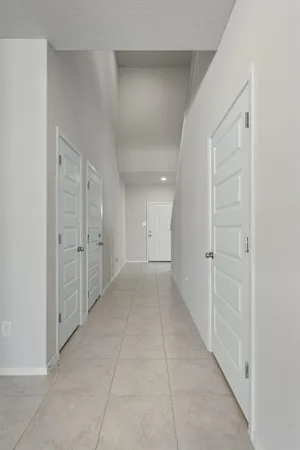 a view of a hallway to rooms