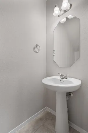 a bathroom with a sink a mirror and vanity