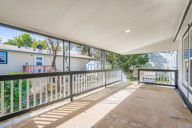 a view of a porch with wooden floor and furniture