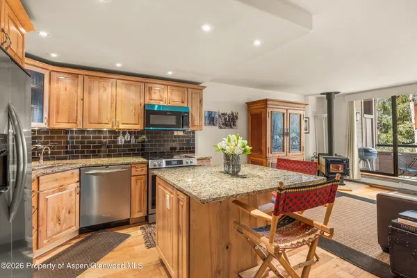 a kitchen with stainless steel appliances granite countertop sink stove and cabinets