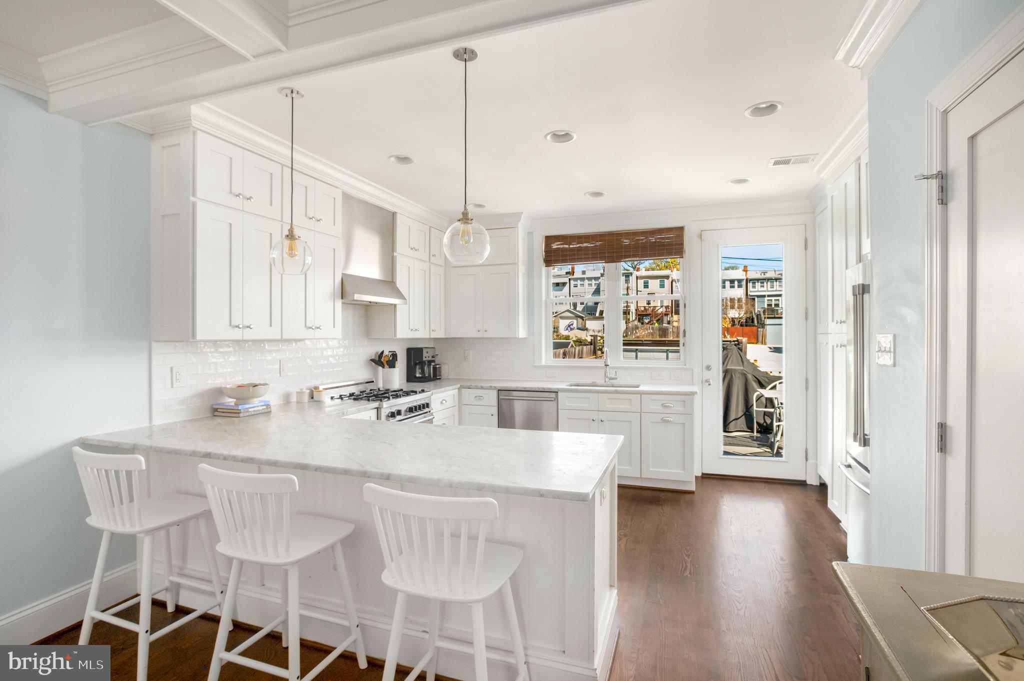 717 Hamilton Street Northwest Washington, DC 20011 - Photo 7 of 27 a kitchen with a sink cabinets and wooden floor