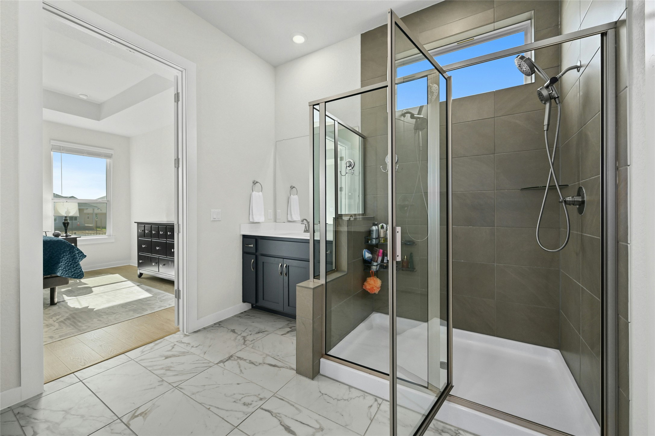 916 Leaning Oak Lane Georgetown, TX 78628 - Photo 15 of 32 Full bathroom featuring a separate walk-in shower, a soaking tub, vanity, light marble finish floors, and recessed lighting