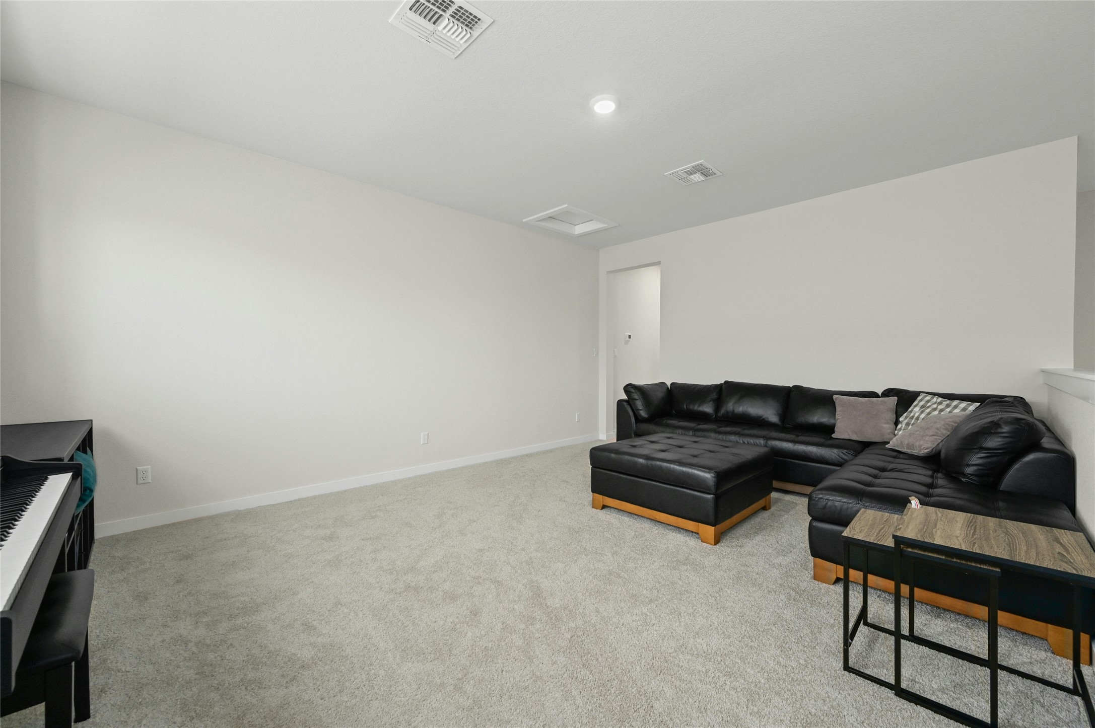 916 Leaning Oak Lane Georgetown, TX 78628 - Photo 20 of 32 Living area with light colored carpet and attic access