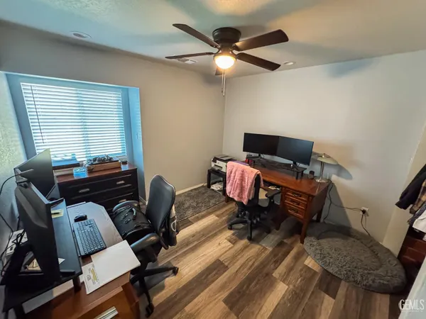 a bedroom with bed and wooden floor