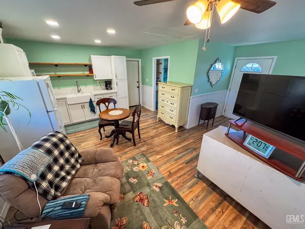 a living room with furniture and a dresser