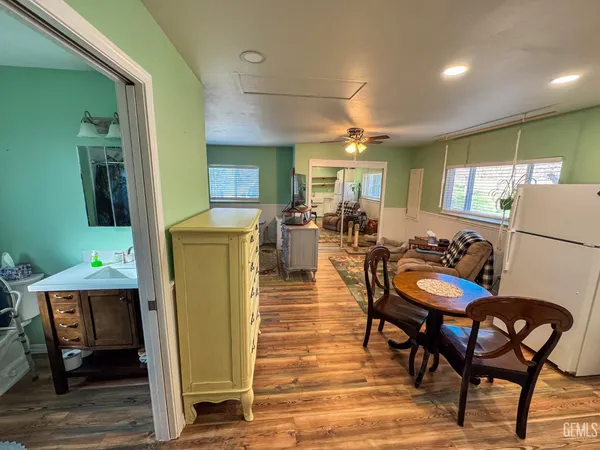 a living room with furniture a flat screen tv and kitchen view