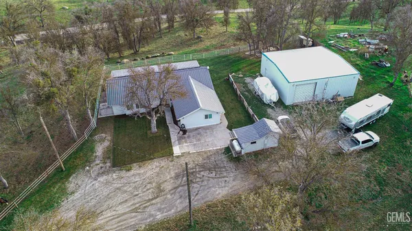 an aerial view of a house with garden space and street view