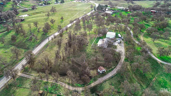 an aerial view of residential house with outdoor space and swimming pool