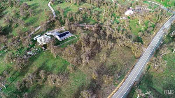 an aerial view of a house with a yard basket ball court and outdoor seating