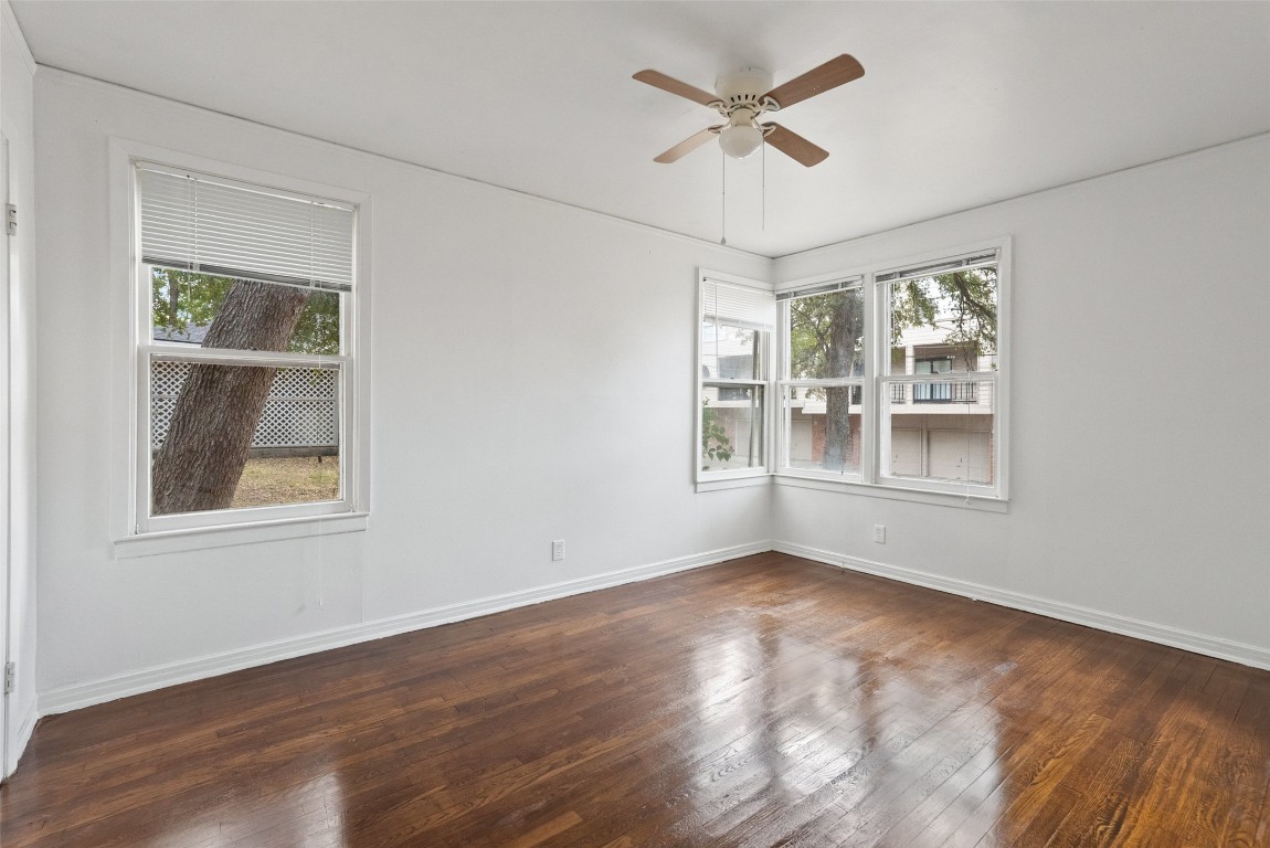 3208 Duval Street Austin, TX 78705 - Photo 12 of 26 a view of an empty room with a window and wooden floor