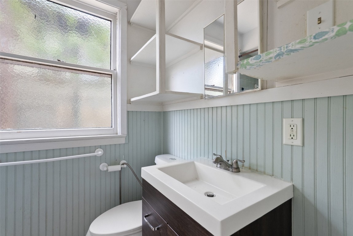 3208 Duval Street Austin, TX 78705 - Photo 15 of 26 a bathroom with a sink a toilet and a mirror