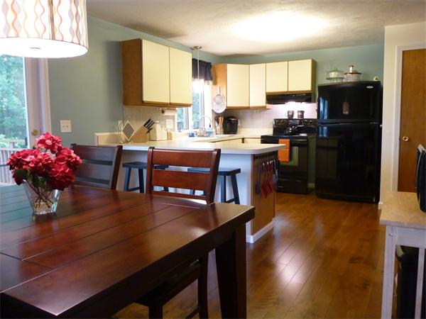 119 Orton Street Extension Worcester, MA 01604 - Photo 12 of 29 a kitchen with granite countertop a table chairs stove and refrigerator