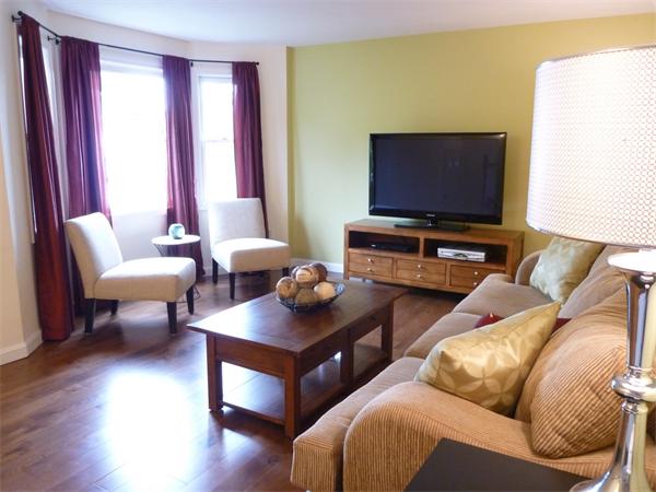 119 Orton Street Extension Worcester, MA 01604 - Photo 3 of 29 a living room with furniture and a flat screen tv