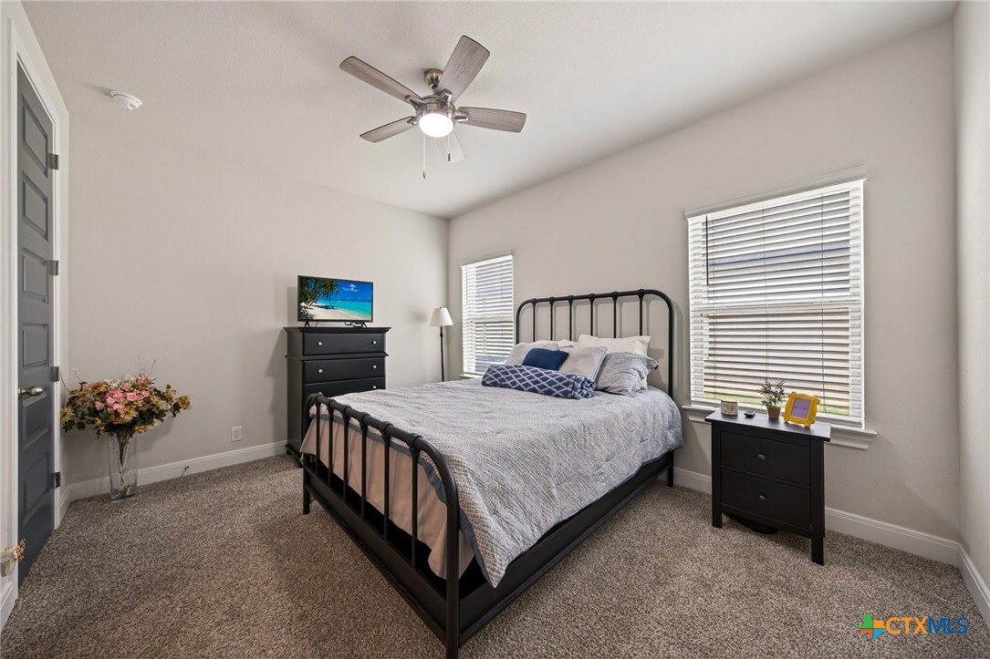 361 Misty Sails Cibolo, TX 78108 - Photo 11 of 48 a bedroom with a bed and a chandelier