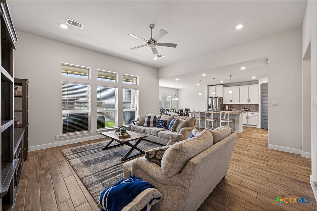 361 Misty Sails Cibolo, TX 78108 - Photo 18 of 48 a living room with furniture floor to ceiling window and wooden floor