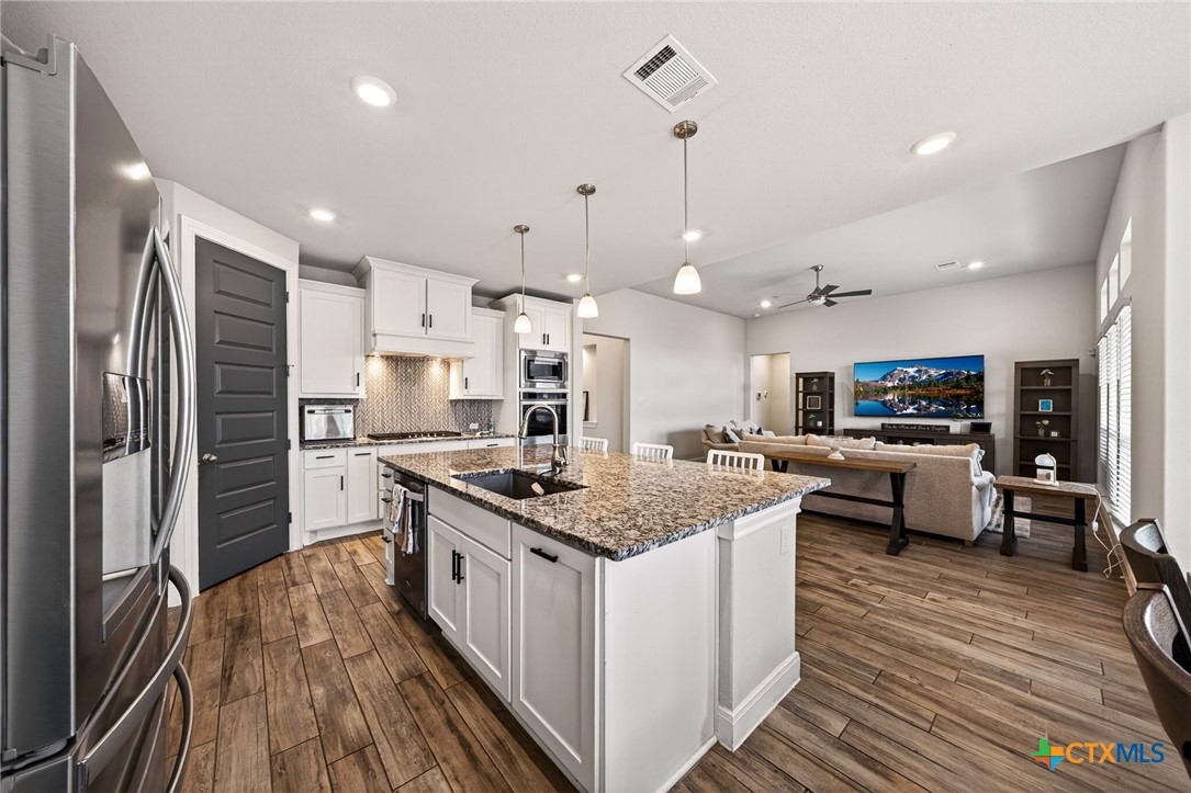 361 Misty Sails Cibolo, TX 78108 - Photo 21 of 48 a kitchen with stainless steel appliances granite countertop a stove and refrigerator