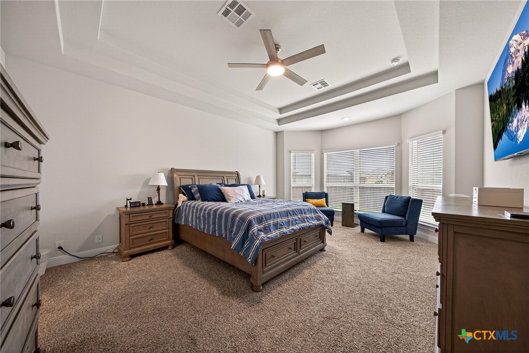361 Misty Sails Cibolo, TX 78108 - Photo 24 of 48 a spacious bedroom with a bed and a chandelier