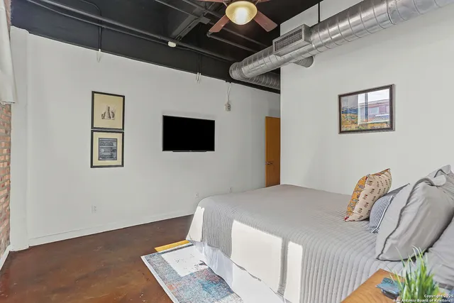 a bed room with a bed and a television