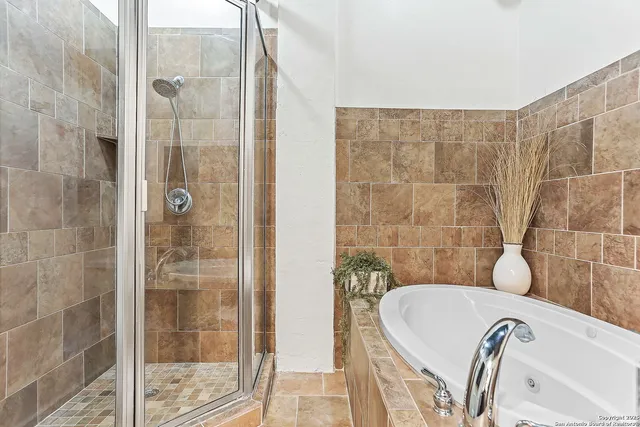 a bathroom with a bathtub and shower