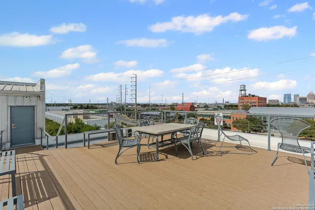 a view of a terrace with wooden benches