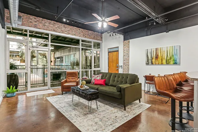 a living room with furniture and a large window