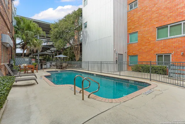 a view of a swimming pool with a lounge chair