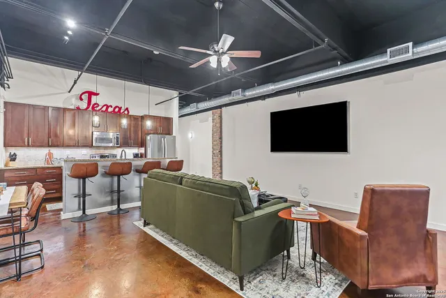 a living room with furniture and a flat screen tv