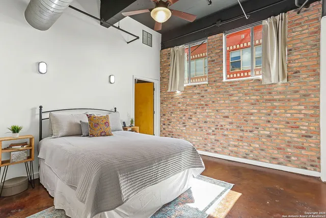 a bedroom with a bed and a potted plant