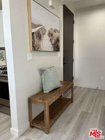 a living room with furniture and wall paintings