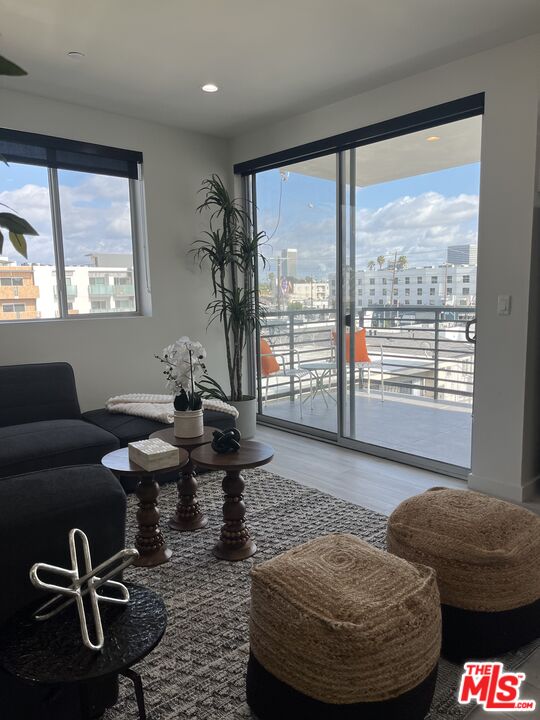124 South Croft Avenue, Unit 403 Los Angeles, CA 90048 - Photo 17 of 31 a living room with furniture and a floor to ceiling window