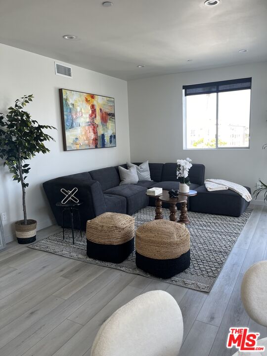 124 South Croft Avenue, Unit 403 Los Angeles, CA 90048 - Photo 21 of 31 a living room with furniture and a large window
